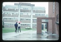 Students walking on campus in the rain